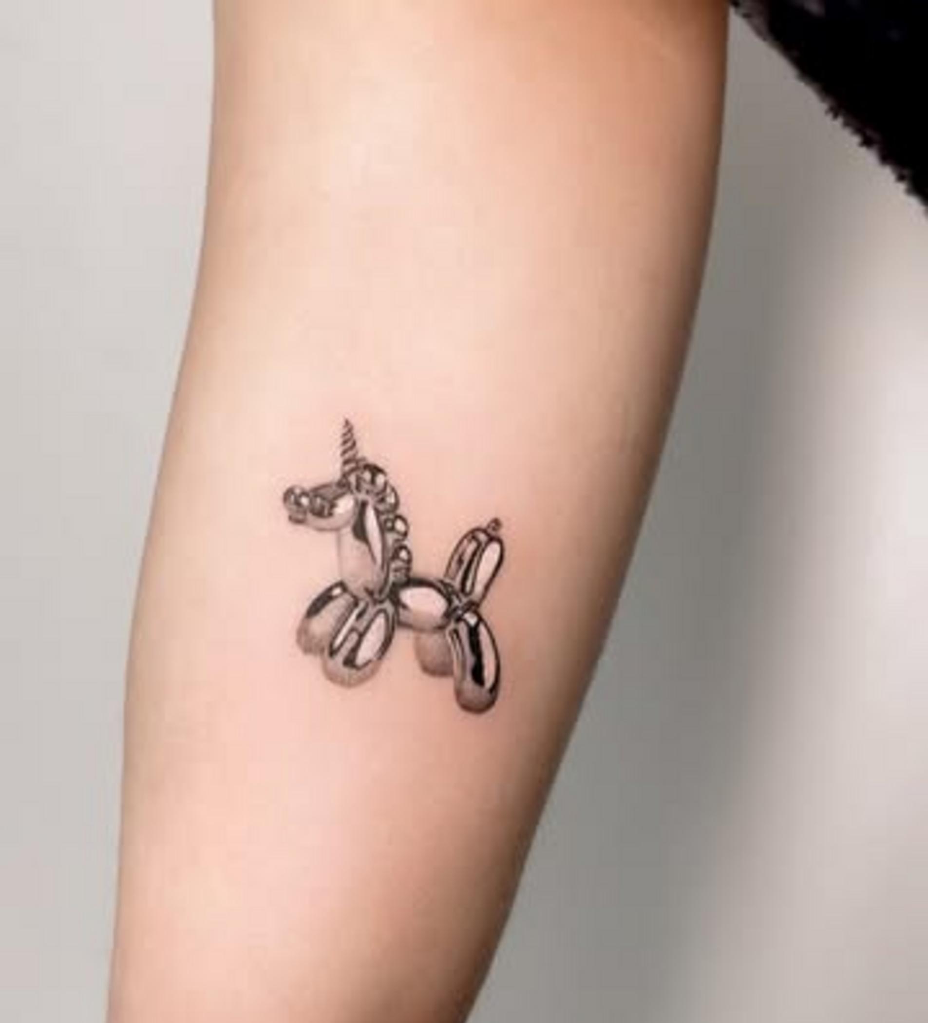 artist applying fine line tattoo process