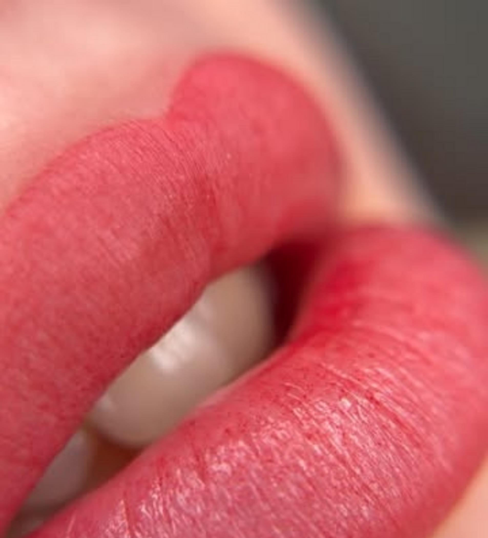 technician applying lip tattoo