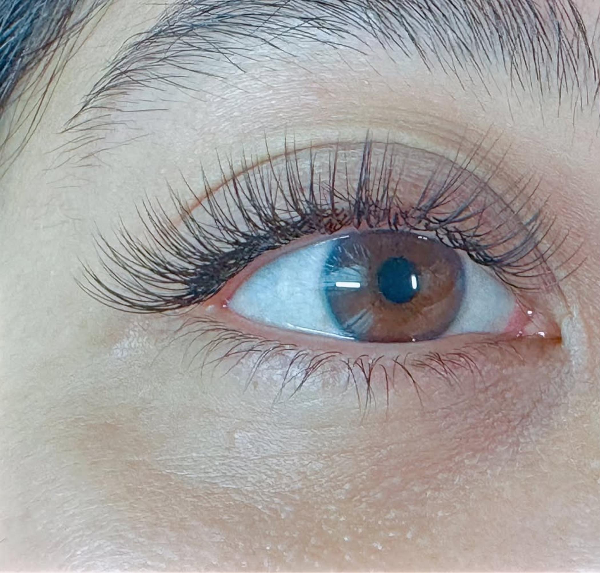 technician performing lash enhancement tattoo